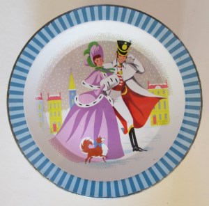 The Quality Street Soldier & Lady out and about, he with a flamboyant red cape