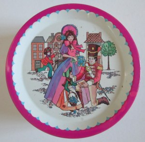 The Quality Street Soldier kneeling down to a small child