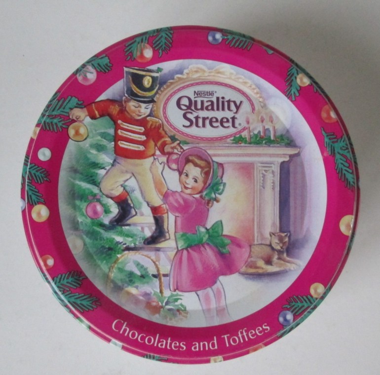 The Quality Street Soldier & Lady children decorate the Christmas tree