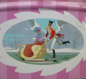 The Quality Street Soldier pushes the Lady in a sleigh