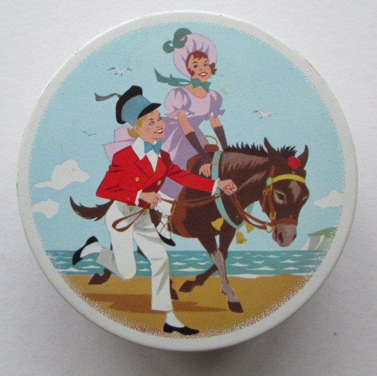 The Quality Street child Soldier & Lady with a donkey on the beach